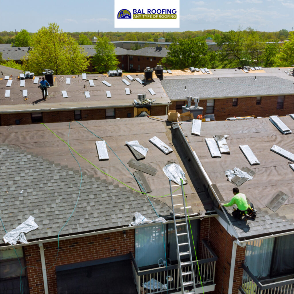 Professional commercial roofing installation in progress by BAL Roofing, flat roof replacement and repair services for apartment buildings